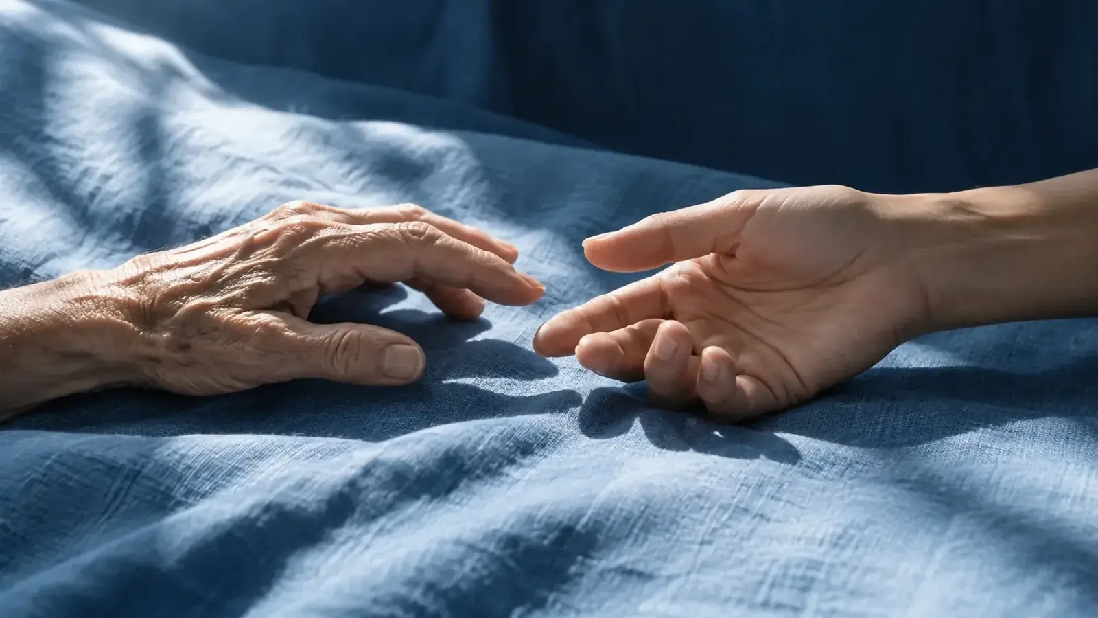 Two hands reaching toward one another